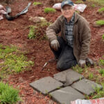 MADAWASKA, Maine -- June 13, 2023 -- Bob Landry, whose family owned the Landry Flower Garden in St. Agatha, recently helped Country Village Estates revamp their gardens. (Courtesy of Country Village Estates)