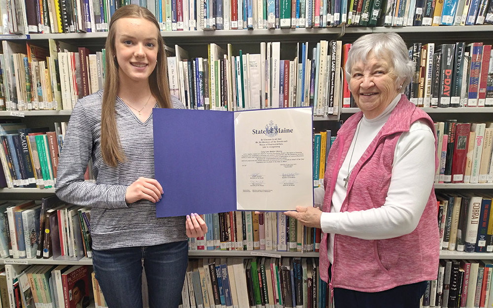 ST. AGATHA, Maine -- June 1, 2023 -- Long Lake Public Library Board President Lauren Paradis (left) and Jackie Ayotte, library co-founder and longtime board president, display the Maine 2022 Spirit of America Foundation Award the library received for its many years of serving the area. (Courtesy of Terry Ouellette)